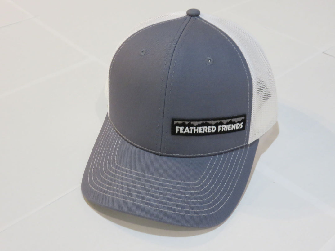 Studio image Feathered Friends Pro Style Offset Logo Trucker Hat steel blue and white colors