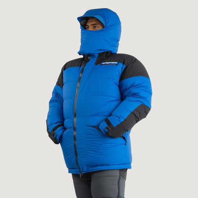 The Feathered Friends Rock & Ice Expedition Down Parka in Royal Blue worn by a model fully zipped up