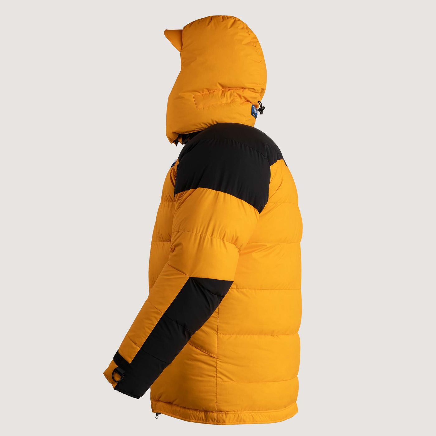 Studio image of the Feathered Friends Rock & Ice Expedition Down Parka Saffron Yellow color viewed from the side