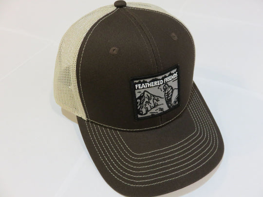 Studio image Feathered Friends Smoking Man Pro Style Trucker Hat charcoal brown and tan colors