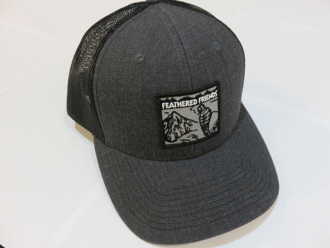Studio image Feathered Friends Smoking Man Pro Style Trucker Hat heather charcoal black colors
