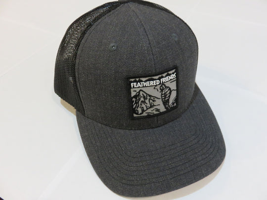 Studio image Feathered Friends Smoking Man Pro Style Trucker Hat heather charcoal black colors