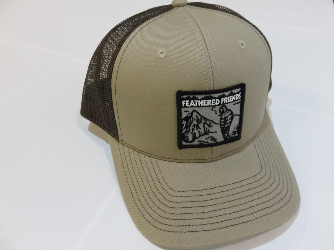 Studio image Feathered Friends Smoking Man Pro Style Trucker Hat khaki and brown colors