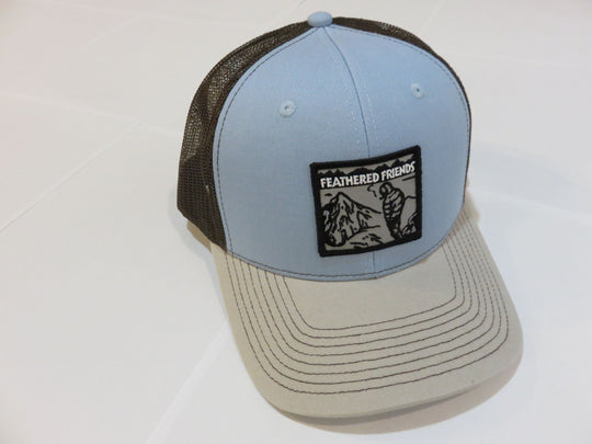 Studio image Feathered Friends Smoking Man Pro Style Trucker Hat light blue natural brown colors