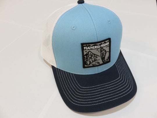 Studio image Feathered Friends Smoking Man Pro Style Trucker Hat light blue navy colors