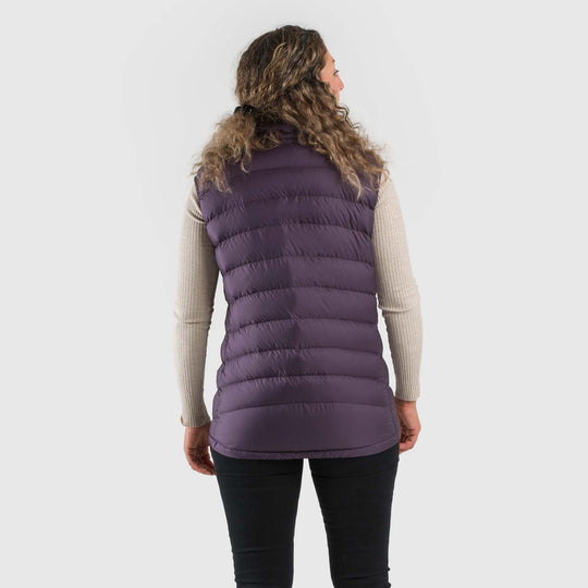 Studio back view of a woman wearing a dusky purple Women's Feathered Friends Eos Down Vest
