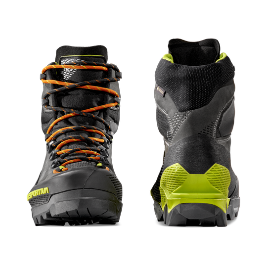 Pair of La Sportiva Aequilibrium LT GTX hiking boots with orange laces and green accent on a white background