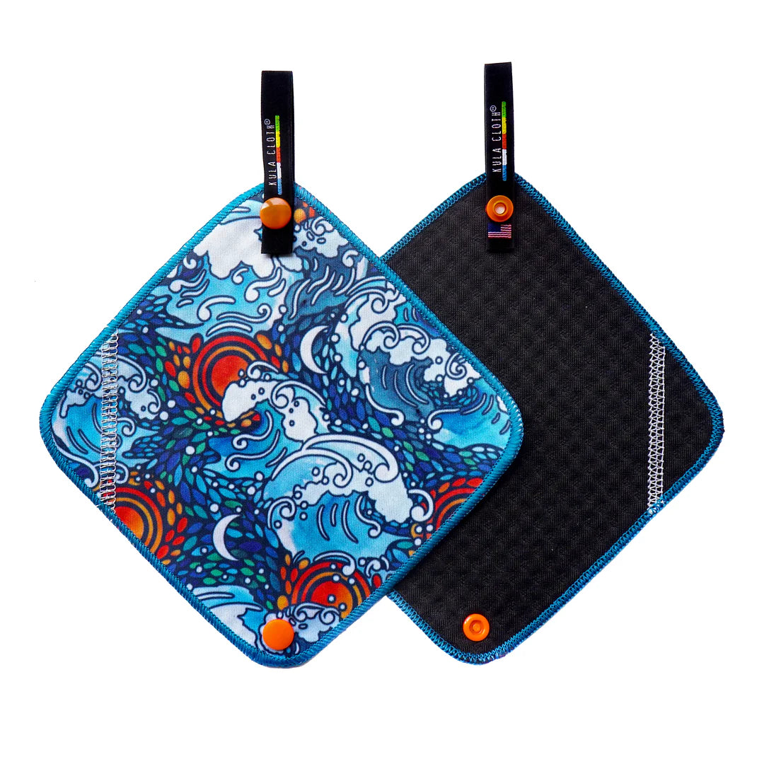 Two pot holders with one featuring a colorful wave design and the other black quilted surface.