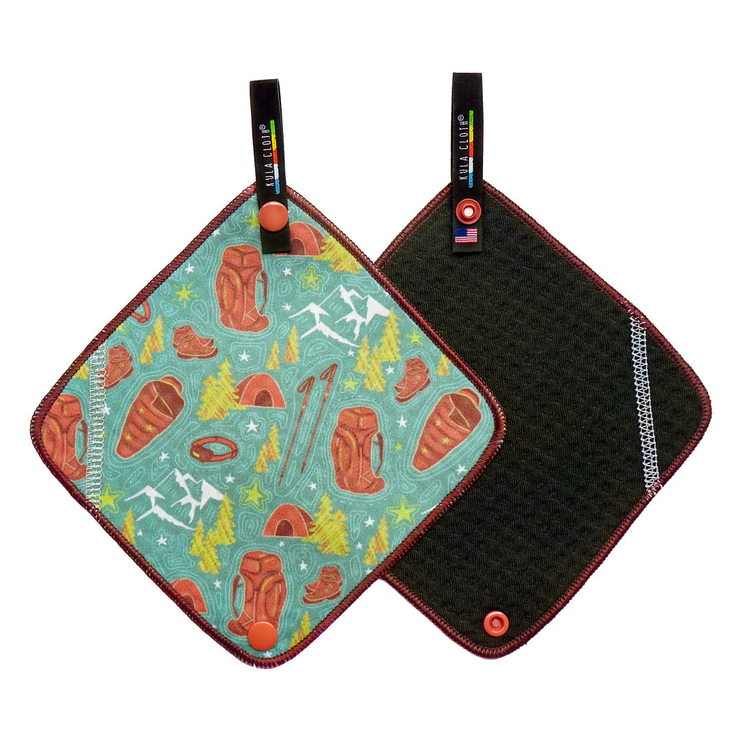 Two pot holders with one featuring a nature-themed design and the other black textured surface.